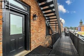 Chatham apartment for rent - A black door is on the left side of a brick wall.