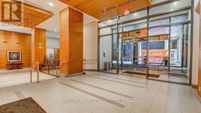 Toronto (Waterfront Communities) condo for rent - The lobby of a building with a glass door entrance.