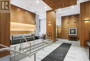 Toronto (Waterfront Communities) condo for rent - A brokerage office with wood paneling and a reception desk.