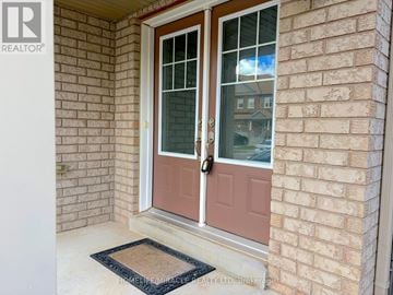 Brampton (Credit Valley) apartment for rent - A door with a glass window and a doorknob is closed.
