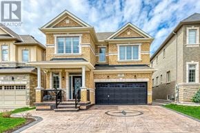 Hamilton (Waterdown) apartment for rent - A large, two-story house with a garage and a driveway.