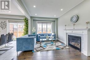 Hamilton (Waterdown) apartment for rent - A living room with a grey couch and a fireplace.