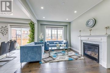 Hamilton (Waterdown) apartment for rent - A living room with a grey couch and a fireplace.