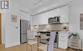 Toronto (Mimico) condo for rent - A modern kitchen with white cabinets and appliances.