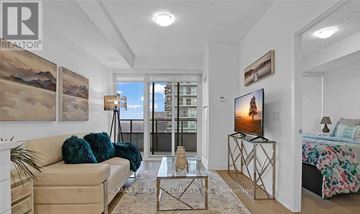 Toronto (Mimico) condo for rent - A living room with a beige couch, a glass coffee table, and a painting on the wall.