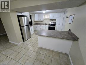Cambridge apartment for rent - A kitchen with white cabinets and a stainless steel refrigerator.