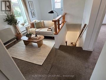 Mississippi Mills triplex for rent - A living room with a white couch and a wooden coffee table.