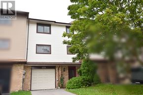 Pickering (Liverpool) townhouse for rent - A house with a white garage door is for sale.