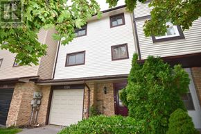 Pickering (Liverpool) townhouse for rent - A house with a white garage door is for sale.
