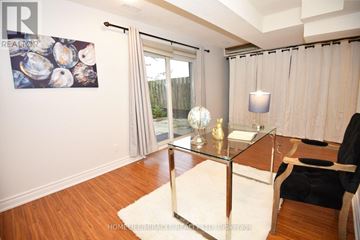 Pickering (Liverpool) townhouse for rent - A living room with a glass coffee table and a painting on the wall.