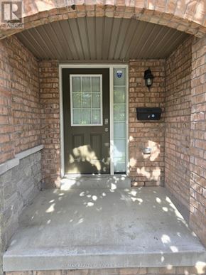 Brampton (Bram East) townhouse for rent - A doorway with a glass door and a small window above it.