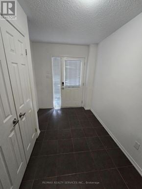 Brampton (Bram East) townhouse for rent - A hallway with a white door and a white wall.