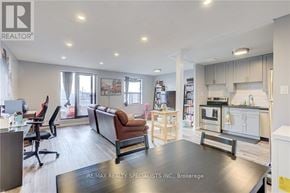 Kitchener condo for rent - A spacious office and kitchen area with a black table in the middle.