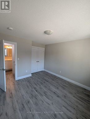 Tillsonburg townhouse for rent - A room with a grey floor and white walls.