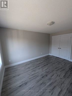 Tillsonburg townhouse for rent - A room with a wooden floor and a white door.