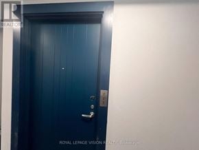 Oshawa (Windfields) condo for rent - A blue door with a silver handle and a number 2 on the right side.