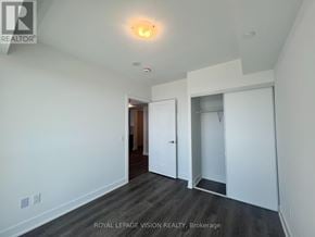 Oshawa (Windfields) condo for rent - A white room with a door and a light on the ceiling.