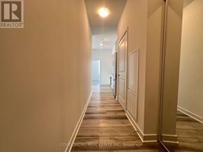 Vaughan (Concord) condo for rent - A long hallway with doors on both sides and a light at the end.