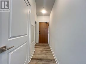 Vaughan (Concord) condo for rent - A hallway with a wooden floor and white walls.