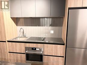 Vaughan (Beverley Glen) condo for rent - A modern kitchen with wooden cabinets and stainless steel appliances.