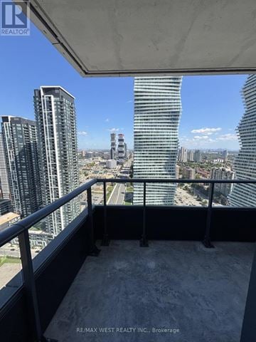 Mississauga (City Centre) condo for rent - A balcony overlooks a cityscape with tall buildings.