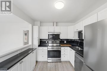 St. Catharines (Downtown) apartment for rent - A modern kitchen with white cabinets and stainless steel appliances.