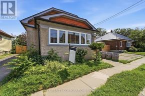 St. Catharines (Downtown) apartment for rent - A house with a brown roof and a sign that says "EX REALTY CORPORATION" in front of it.