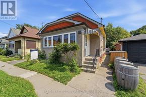 St. Catharines (Downtown) apartment for rent - A house with a red roof and a sign that says "REALTOR" in the front yard.