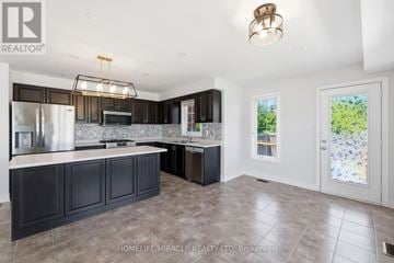 Hamilton (Waterdown) townhouse for rent - A modern kitchen with dark brown cabinets and a white countertop.