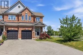 Hamilton (Waterdown) townhouse for rent - A large brick house with two garage doors in front.