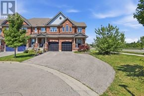 Hamilton (Waterdown) townhouse for rent - A large, two-story house with a driveway in front.