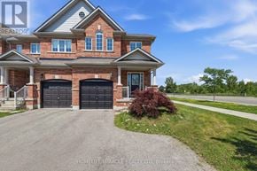 Hamilton (Waterdown) townhouse for rent - A large house with a driveway in front of it.