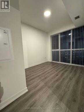 Vaughan (Vaughan Corporate Centre) condo for rent - A room with wooden flooring and white walls.