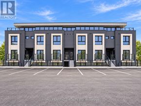 Niagara Falls (Oldfield) townhouse for rent - A modern building with a parking lot in front of it.