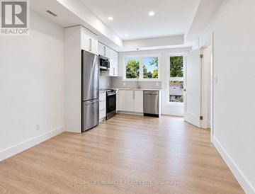 Niagara Falls (Oldfield) townhouse for rent - A kitchen with white cabinets and a stainless steel refrigerator.