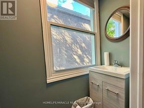 Welland (Welland Downtown) apartment for rent - A bathroom with a sink, mirror, and a window.