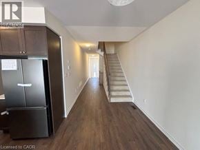 Erin townhouse for rent - A spacious hallway with a staircase leading to the second floor.