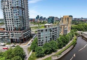 Ottawa condo for rent - A river runs through a city with buildings on both sides.