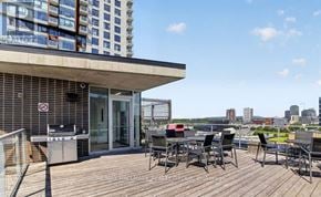 Ottawa condo for rent - A balcony with a table and chairs overlooks a cityscape.
