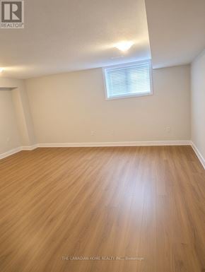 Ottawa apartment for rent - A room with wooden flooring and a window with blinds.