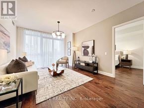 Toronto (Annex) condo for rent - A well-lit living room with a couch, chair, and coffee table.