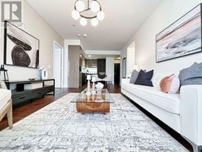 Toronto (Annex) condo for rent - A living room with a white couch, a coffee table, and a rug.