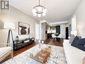 Toronto (Annex) condo for rent - A living room with a white couch and a wooden coffee table.