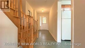 Aurora (Aurora Grove) townhouse for rent - A hallway with a wooden staircase and a white door at the end.