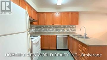 Aurora (Aurora Grove) townhouse for rent - A kitchen with wooden cabinets and a white refrigerator.