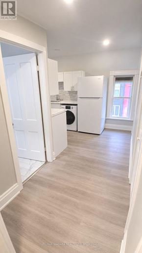 Niagara Falls (Dorchester) apartment for rent - A kitchen with white appliances and a white door.