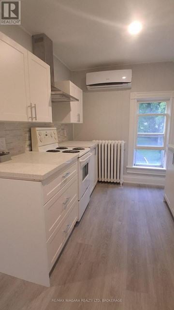 Niagara Falls (Dorchester) apartment for rent - A kitchen with white cabinets and a window with a white frame.