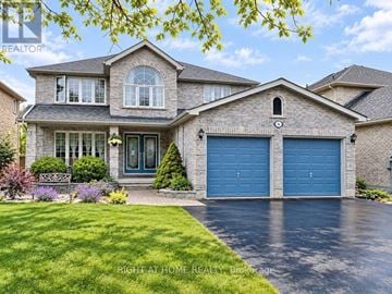 Barrie (Ardagh) apartment for rent - A large house with a blue garage door is for sale.