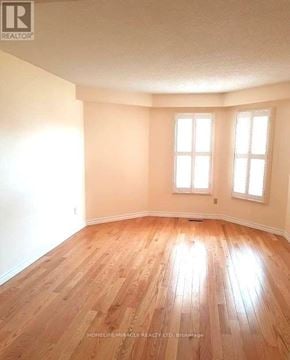 Oshawa (Pinecrest) apartment for rent - A room with wooden flooring and two windows.