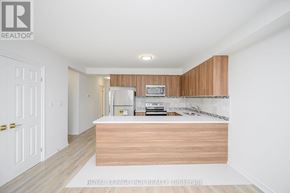 Orangeville multi-family for rent - A kitchen with wooden cabinets and a countertop.